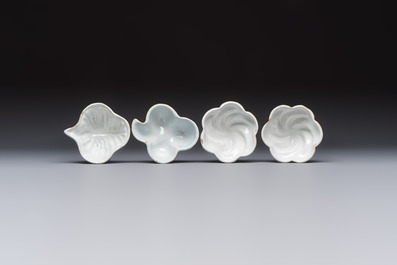 A collection of nine white-glazed Dutch Delft pudding moulds, a mustard pot and a two-handled strainer, 18th C.