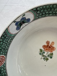 A Chinese famille verte bowl with bird and butterflies among flowers, lozenge mark, Kangxi