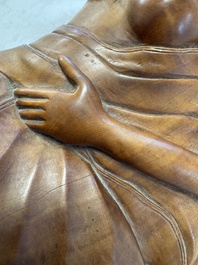 A Balinese carved wooden sculpture of a reclining lady, first half 20th C.
