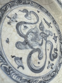 An unusual Chinese blue and white celadon-back 'Buddhist Lion' plate, Ming