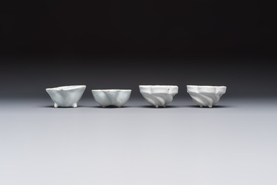 A collection of nine white-glazed Dutch Delft pudding moulds, a mustard pot and a two-handled strainer, 18th C.
