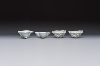 A collection of nine white-glazed Dutch Delft pudding moulds, a mustard pot and a two-handled strainer, 18th C.