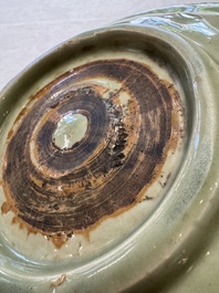 A Chinese Longquan celadon inscribed dish with incised floral design, Ming