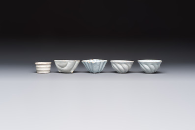 A collection of nine white-glazed Dutch Delft pudding moulds, a mustard pot and a two-handled strainer, 18th C.