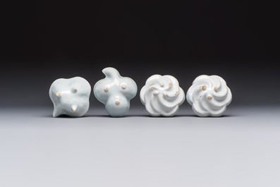 A collection of nine white-glazed Dutch Delft pudding moulds, a mustard pot and a two-handled strainer, 18th C.