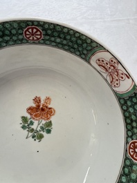 A Chinese famille verte bowl with bird and butterflies among flowers, lozenge mark, Kangxi