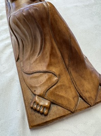 A Balinese carved wooden sculpture of a reclining lady, first half 20th C.