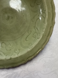 A Chinese Longquan celadon inscribed dish with incised floral design, Ming