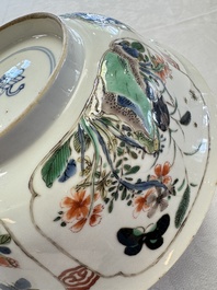 A Chinese famille verte bowl with bird and butterflies among flowers, lozenge mark, Kangxi