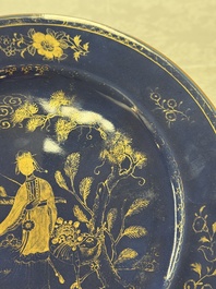 A Chinese gilt-decorated powder-blue-ground 'Elegant Beauty and Boy' dish, Kangxi