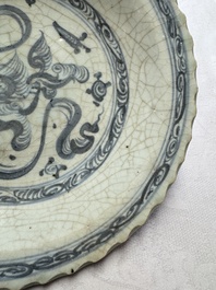 An unusual Chinese blue and white celadon-back 'Buddhist Lion' plate, Ming