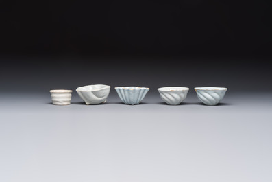 A collection of nine white-glazed Dutch Delft pudding moulds, a mustard pot and a two-handled strainer, 18th C.