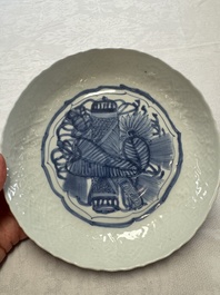 A Chinese blue and white plate with a relief-moulded rim, Wanli