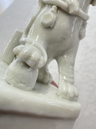Two Chinese Dehua blanc-de-Chine Buddhist lions, three famille rose figures, and a white-glazed group, Kangxi and later