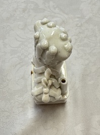 Two Chinese Dehua blanc-de-Chine Buddhist lions, three famille rose figures, and a white-glazed group, Kangxi and later