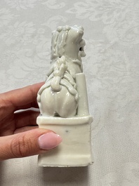 Two Chinese Dehua blanc-de-Chine Buddhist lions, three famille rose figures, and a white-glazed group, Kangxi and later