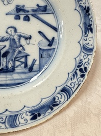 A pair of rare blue and white Dutch Delft 'Shoemaker' plates, 18th C.