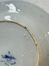 A pair of rare blue and white Dutch Delft 'Shoemaker' plates, 18th C.