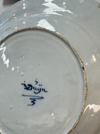 A pair of rare blue and white Dutch Delft 'Shoemaker' plates, 18th C.