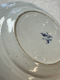 A pair of rare blue and white Dutch Delft 'Shoemaker' plates, 18th C.