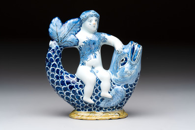 A blue and white Dutch Delft ewer in the shape of a putto on a dolphin on a wavy green ground, 18th C.