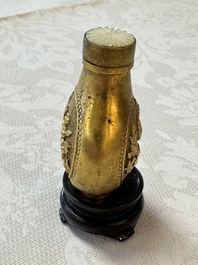 A Chinese gilt-bronze and mother-of-pearl-inlaid snuff bottle with birds among flowering branches, Guangxu mark and of the period