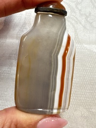 Five Chinese hardstone and glass snuff bottles, 20th C.