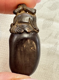A group of four Chinese porcelain and agate snuff bottles, a miniature vase and a carved seed, Yongzheng and Qianlong marks, 19/20th C.
