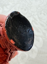 Nine Chinese cinnabar lacquer snuff bottles and a covered box, Qianlong marks, 19/20th C.