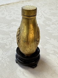 A Chinese gilt-bronze and mother-of-pearl-inlaid snuff bottle with birds among flowering branches, Guangxu mark and of the period