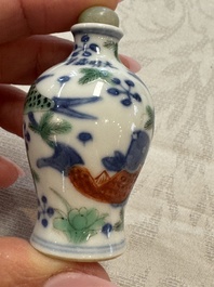 A Chinese iron-red 'Dragon' covered box, a blue and white '100 Boys' and a famille verte 'Fish' snuff bottle, Shunzhi mark, 19th C.