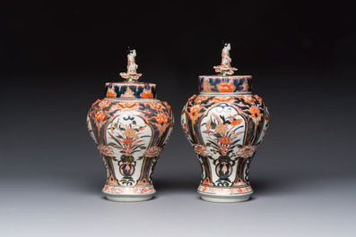 A pair of Japanese Imari baluster vases and covers on wooden stands, Edo, 18th C.