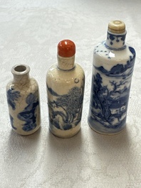 Three Chinese blue and white snuff bottles with landscapes and 'Buddhist Lions', Yongzheng marks, 19th C.