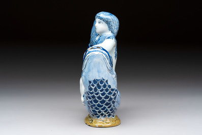 A blue and white Dutch Delft ewer in the shape of a putto on a dolphin on a wavy green ground, 18th C.