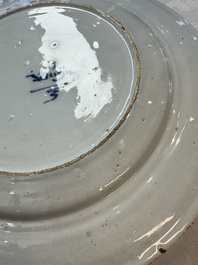 A pair of rare blue and white Dutch Delft 'Shoemaker' plates, 18th C.