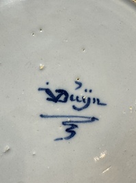 A pair of rare blue and white Dutch Delft 'Shoemaker' plates, 18th C.