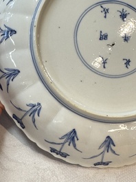 A pair of Chinese blue and white 'Hunting' plates, Chenghua marks, Kangxi