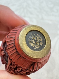 Nine Chinese cinnabar lacquer snuff bottles and a covered box, Qianlong marks, 19/20th C.