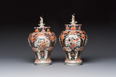 A pair of Japanese Imari baluster vases and covers on wooden stands, Edo, 18th C.