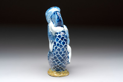 A blue and white Dutch Delft ewer in the shape of a putto on a dolphin on a wavy green ground, 18th C.