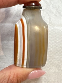 Five Chinese hardstone and glass snuff bottles, 20th C.