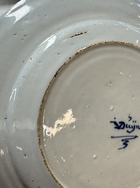 A pair of rare blue and white Dutch Delft 'Shoemaker' plates, 18th C.