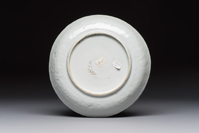 A Chinese blue and white plate with a relief-moulded rim, Wanli
