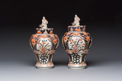 A pair of Japanese Imari baluster vases and covers on wooden stands, Edo, 18th C.
