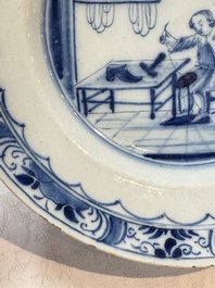 A pair of rare blue and white Dutch Delft 'Shoemaker' plates, 18th C.