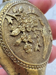 A Chinese gilt-bronze and mother-of-pearl-inlaid snuff bottle with birds among flowering branches, Guangxu mark and of the period