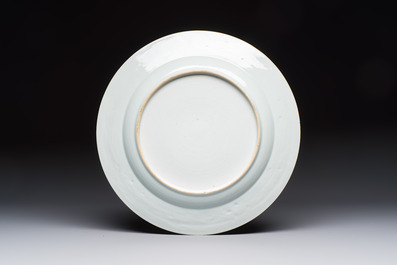A Chinese gilt-decorated powder-blue-ground 'Elegant Beauty and Boy' dish, Kangxi