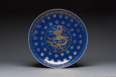A large Chinese gilt-decorated powder-blue-ground 'Dragon' dish on a later wooden stand, Guangxu mark and of the period