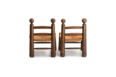 A pair of chairs in oak and straw, attributed to Charles Dudouyt, France, mid 20th C.