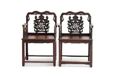 A pair of Chinese carved hongmu armchairs, 19th C.
